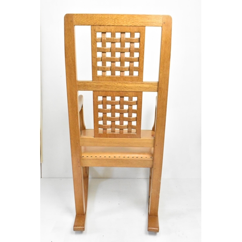 59 - Robert 'Mouseman' Thompson (1876-1955) An oak rocking chair, circa 1974, with two lattice panel back... 