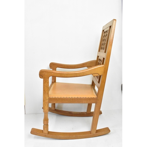 59 - Robert 'Mouseman' Thompson (1876-1955) An oak rocking chair, circa 1974, with two lattice panel back... 