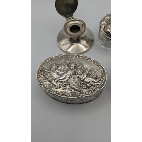 100 - A white metal trinket box stamped 800, embossed with cherubs, together with a sterling silver dressi... 