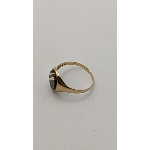 69 - A 9ct gold and onyx signet ring, 2.4g
Location: RING