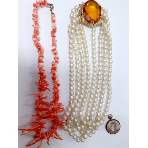 121 - A multi-string simulated pearl necklace with gold tone and large citrine coloured and faceted glass ... 