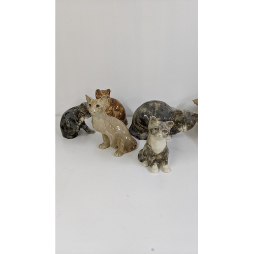 306 - A group of seven Winstanley ceramic cats to include a Winstanley ginger cat with glass eyes, 21cm h ... 