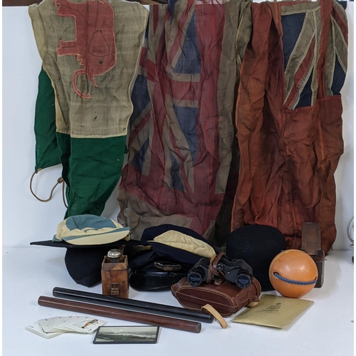 468 - A mixed lot to include vintage flags, a pair of Colmont Lumex binoculars, various vintage hats and o... 