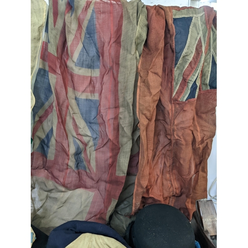 468 - A mixed lot to include vintage flags, a pair of Colmont Lumex binoculars, various vintage hats and o... 