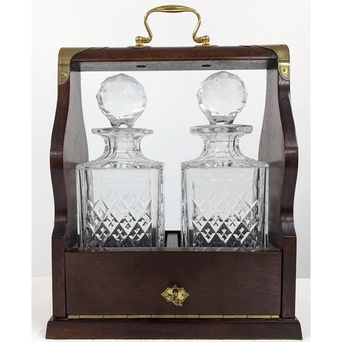 481 - A mid/late 20th century mahogany and brass bound Tantalus fitted with two crystal cut decanters, Loc... 