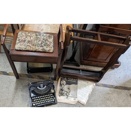 484 - A mixed lot to include an early 20th century oak umbrella stand, typewriter, piano stool, cutlery an... 