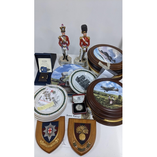 485 - A mixed lot to include two porcelain models of soldiers, collectors plates, Royal Mint five pound co... 