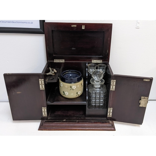 496 - An early 20th century mahogany smokers cabinet with a decanter and glasses, Location:4.1