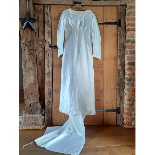54 - A bespoke 1960's white satin and embroidered wedding gown with train having an Broderie Anglaise sty... 
