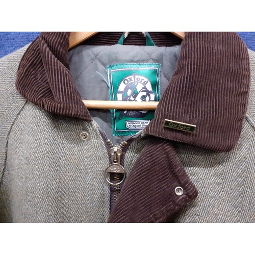 78 - An Oxford Wear green herringbone country pursuit jacket with brown cord collar and Oxford badge, siz... 