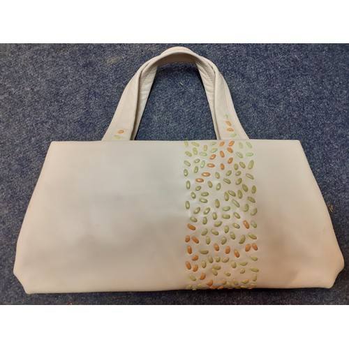 239 - A quantity of modern fashion bags to include a late 20th Century cream Radley handbag with leaf cut-... 