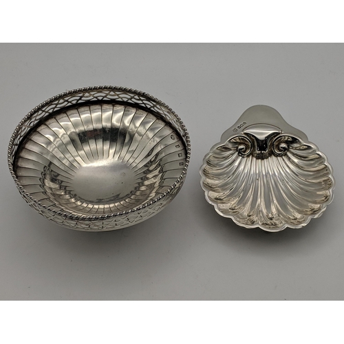 126 - Two silver dishes, one with a pierced rim on a pedestal base and shell dish on ball feet, Sheffield ... 