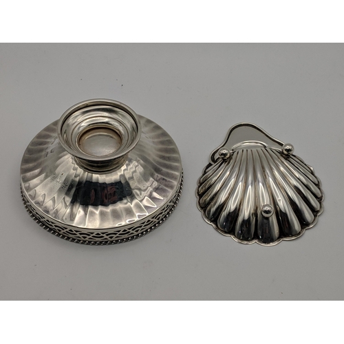 126 - Two silver dishes, one with a pierced rim on a pedestal base and shell dish on ball feet, Sheffield ... 