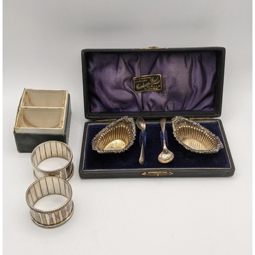 129 - Silver to include a pair of salts boxed hallmarked Birmingham 1899, together with a pair of napkin r... 