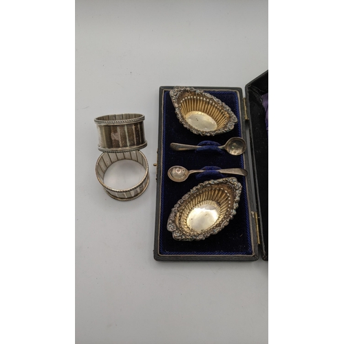 129 - Silver to include a pair of salts boxed hallmarked Birmingham 1899, together with a pair of napkin r... 