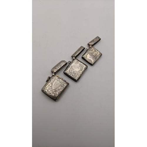 133 - Three silver vesta cases, all having floral engraved detail, to include one dated Birmingham 1905, t... 