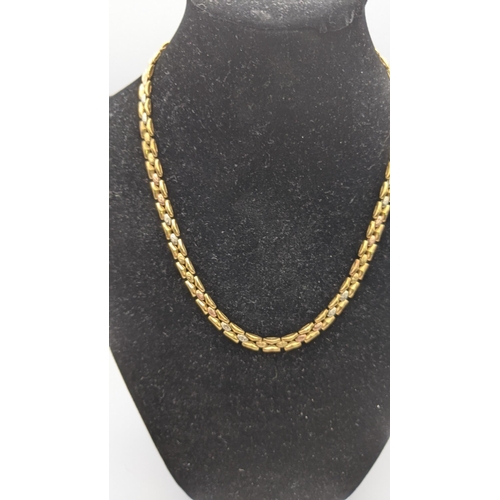 134 - A 9ct gold and white metal tri-coloured necklace 13g Location: CAB4