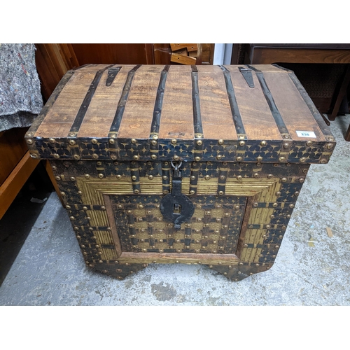 238 - An Indian hardwood dowry chest, iron strap and brass studwork decoration, interior with storage area... 