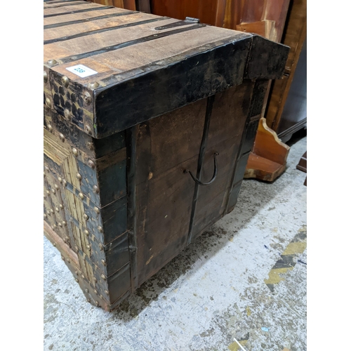 238 - An Indian hardwood dowry chest, iron strap and brass studwork decoration, interior with storage area... 