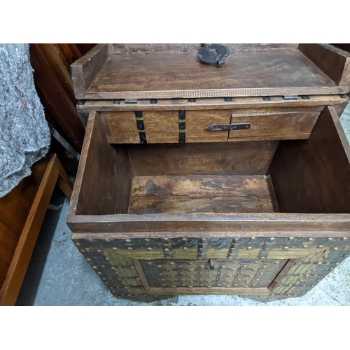 238 - An Indian hardwood dowry chest, iron strap and brass studwork decoration, interior with storage area... 