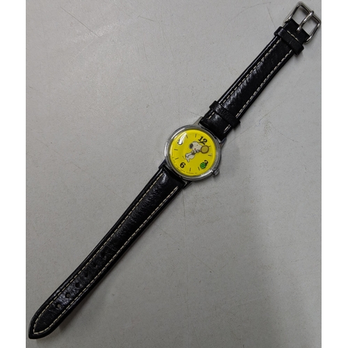 73 - A Snoopy tennis unisex wristwatch with a quartz movement, yellow face, Arabic and baton dials on a b... 