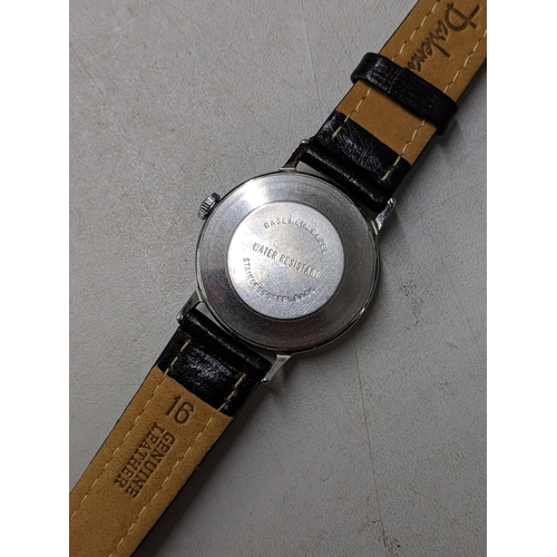 73 - A Snoopy tennis unisex wristwatch with a quartz movement, yellow face, Arabic and baton dials on a b... 