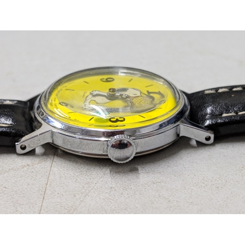 73 - A Snoopy tennis unisex wristwatch with a quartz movement, yellow face, Arabic and baton dials on a b... 