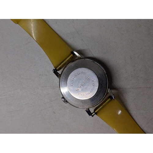 74 - A Snoopy tennis unisex wristwatch with a quartz movement, yellow face, Arabic and baton dials on a b... 