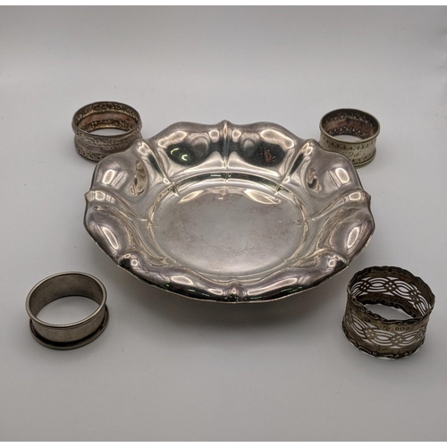 103 - A white metal dish together with two silver and two white metal napkin rings, total weight, 167.1g
L... 