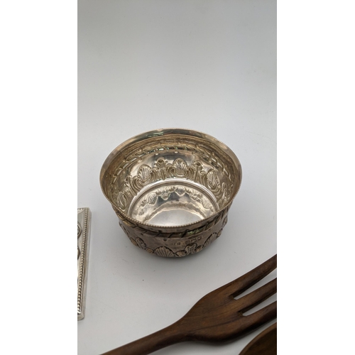 111 - Sterling silver handled and wooden salad servers, together with a silver embossed bowl and candlesti... 