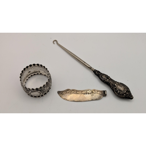 118 - Silver items to include a candlestick, a knife blade, a cigarette case, a silver handled button hook... 