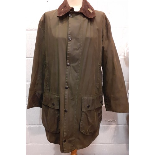 36 - Barbour-A green 'Border' wax cotton coat having a brown cord collar with gold tone branded badge, 2 ... 