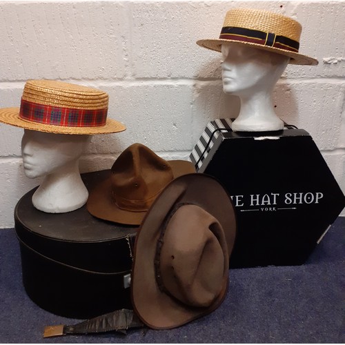 73 - A group of four 20th Century hats comprising 2 straw boaters and 2 wide brim brown felt hats to incl... 