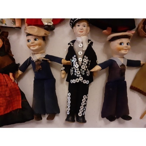 84 - A collection of vintage dolls of the world to include a Chad Valley rag doll with green checked dres... 