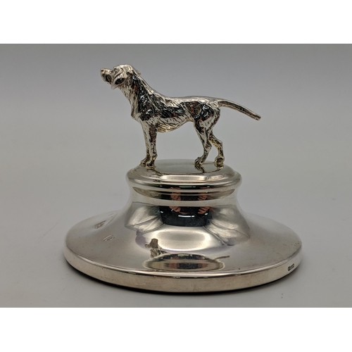 81 - A pair of silver candlesticks and silver paperweight surmounted by a dog, combined weight 514.9g Loc... 