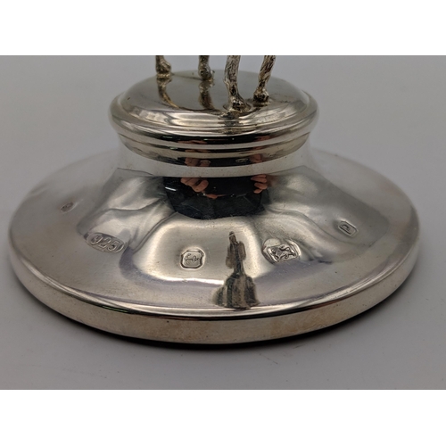 81 - A pair of silver candlesticks and silver paperweight surmounted by a dog, combined weight 514.9g Loc... 