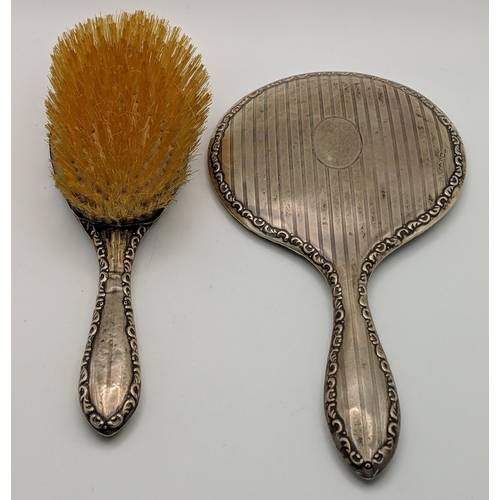 84 - A silver backed hairbrush and hand mirror Location: 4.4