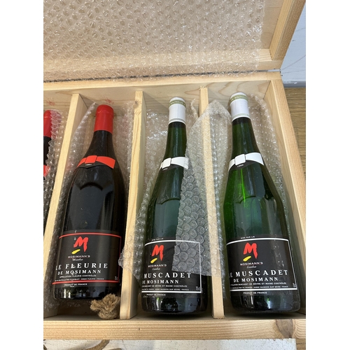 136 - A wooden case of six mixed bottles of De Mosimann to include Champagne, Le Fleurie, Muscadet Locatio... 