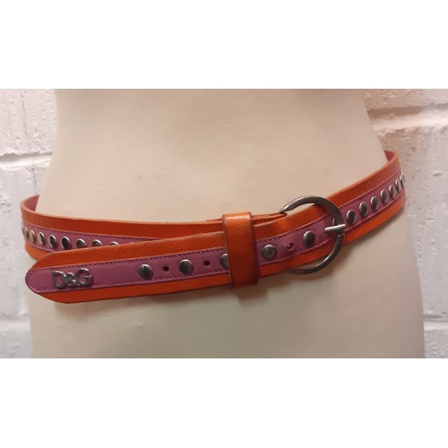 94 - Dolce & Gabbana-An orange and pink D&G belt with silver tone buckle
Condition: Slight areas of wear ... 