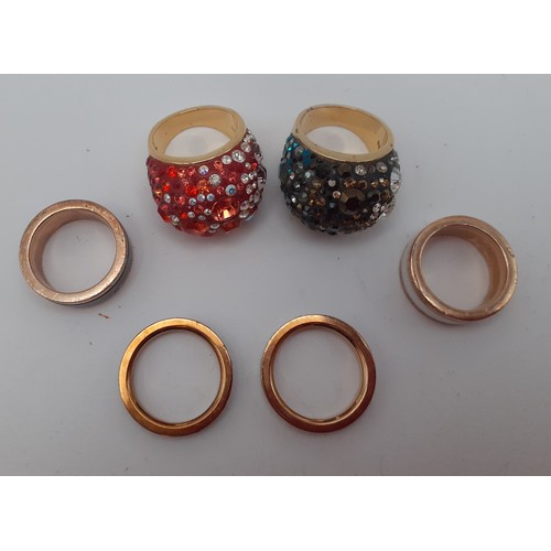 96 - Six modern fashion rings comprising 2 Thomas Sabo gold tone and crystal bands and 4 Swarovski gold t... 