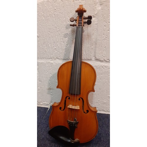 194 - A ⅛ size violin, no internal labels, back measurement 26½cm, total length 44cm, no bow, having a bla... 