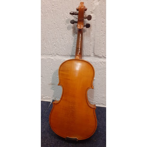 194 - A ⅛ size violin, no internal labels, back measurement 26½cm, total length 44cm, no bow, having a bla... 