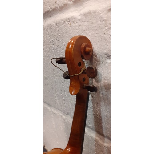 194 - A ⅛ size violin, no internal labels, back measurement 26½cm, total length 44cm, no bow, having a bla... 