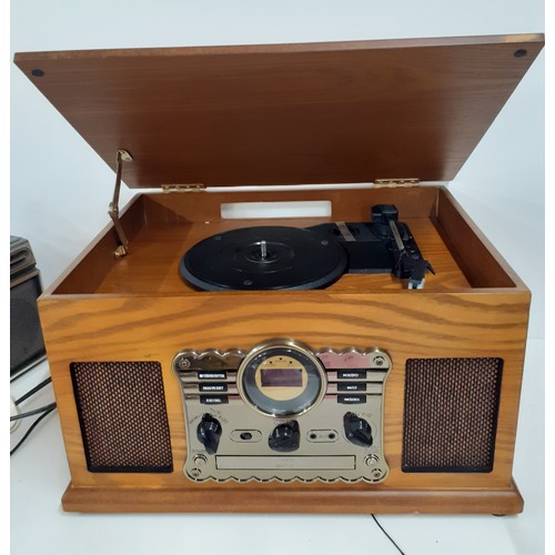 193 - A reproduction music centre in veneered case together with a Sanyo portable tape and radio player. L... 