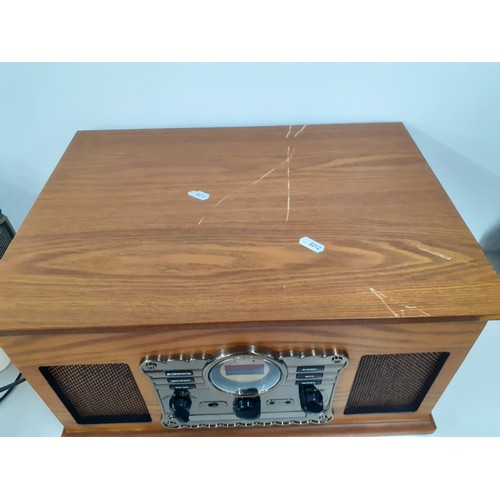 193 - A reproduction music centre in veneered case together with a Sanyo portable tape and radio player. L... 