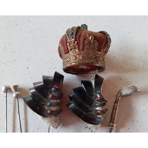 105 - An early 20th Century pin/hat pin cushion in the form of a crown with red velvet and gold tones toge... 