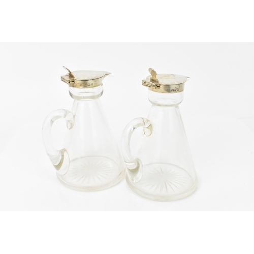 208 - A pair of Edwardian silver mounted whisky tots by Hukin & Heath, Birmingham 1908, each with glass co... 