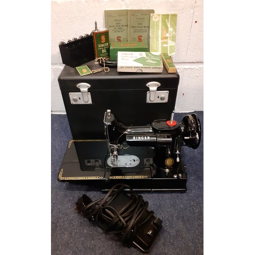 14 - A 1955 Singer Featherweight 222K electric sewing machine with accessories and black travel case toge... 