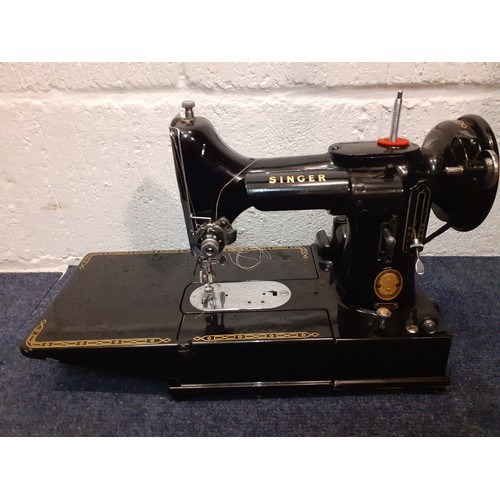 14 - A 1955 Singer Featherweight 222K electric sewing machine with accessories and black travel case toge... 