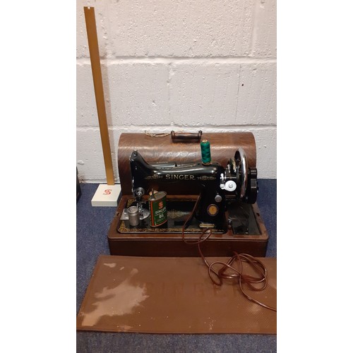 75 - A 1950's 99k electric Singer sewing machine serial number EG043144 with domed oak case and accessori... 